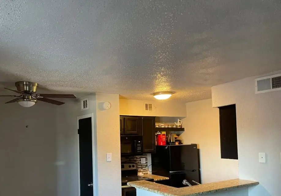 The same apartment living room with the ceiling rebuilt and textured to match.