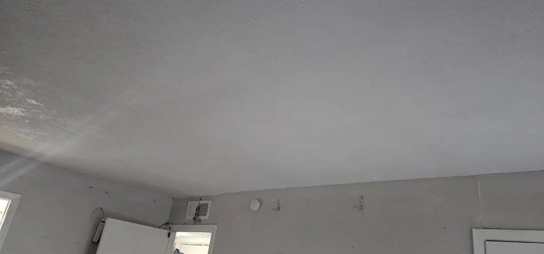 Finished, painted ceiling above the living room walls and doors.